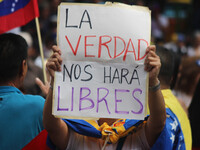 An activist is holding a banner with political phrases during a rally in downtown San Cristobal, Venezuela, on August 17, 2024. Citizens opp...