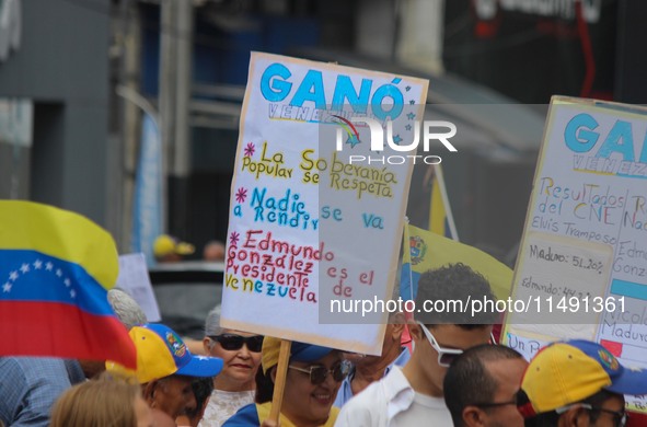 An activist is holding a banner with political phrases during a rally in downtown San Cristobal, Venezuela, on August 17, 2024. Citizens opp...