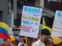 An activist is holding a banner with political phrases during a rally in downtown San Cristobal, Venezuela, on August 17, 2024. Citizens opp...