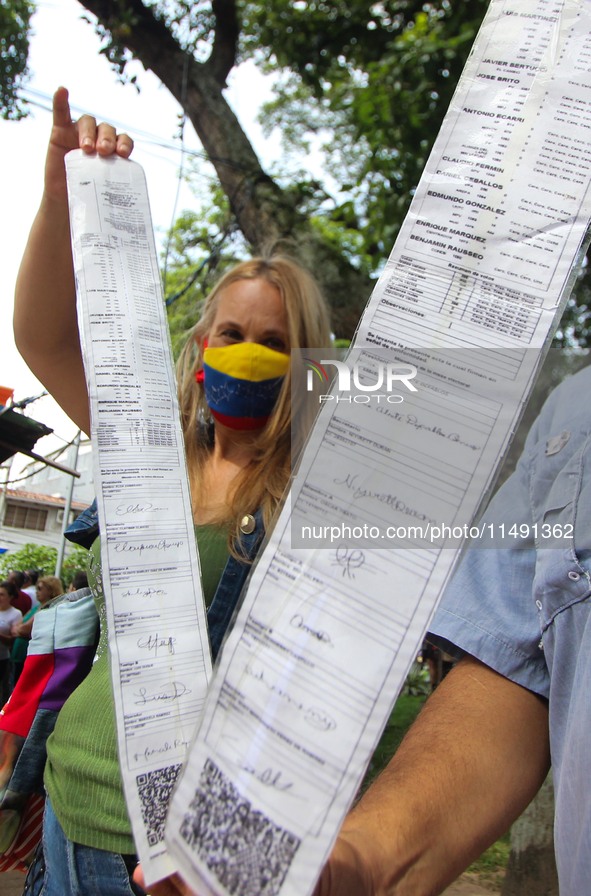 An activist is holding copies of the voting records during a rally in Los Mangos square in San Cristobal, Venezuela, on August 17, 2024. Cit...