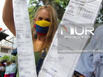 An activist is holding copies of the voting records during a rally in Los Mangos square in San Cristobal, Venezuela, on August 17, 2024. Cit...