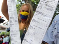 An activist is holding copies of the voting records during a rally in Los Mangos square in San Cristobal, Venezuela, on August 17, 2024. Cit...