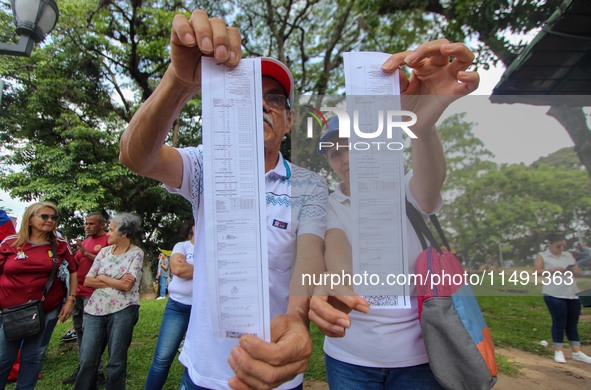 An activist is holding copies of the voting records during a rally in Los Mangos square in San Cristobal, Venezuela, on August 17, 2024. Cit...