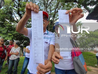 An activist is holding copies of the voting records during a rally in Los Mangos square in San Cristobal, Venezuela, on August 17, 2024. Cit...