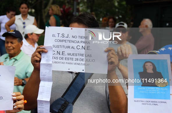 An activist is holding a banner with political phrases during a rally in downtown San Cristobal, Venezuela, on August 17, 2024. Citizens opp...