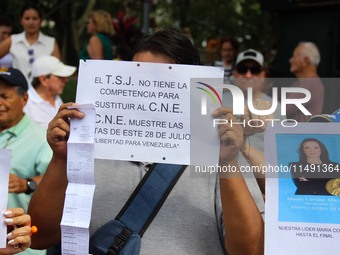 An activist is holding a banner with political phrases during a rally in downtown San Cristobal, Venezuela, on August 17, 2024. Citizens opp...