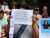 An activist is holding a banner with political phrases during a rally in downtown San Cristobal, Venezuela, on August 17, 2024. Citizens opp...