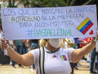 An activist is holding a banner with political phrases during a rally in downtown San Cristobal, Venezuela, on August 17, 2024. Citizens opp...