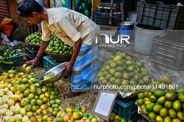 A shopkeeper is selling mangoes at a fruit shop at the Chalai market in Thiruvananthapuram, Kerala, India, on April 13, 2024. The Chalai Mar...