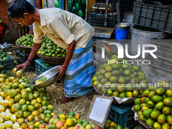 A shopkeeper is selling mangoes at a fruit shop at the Chalai market in Thiruvananthapuram, Kerala, India, on April 13, 2024. The Chalai Mar...