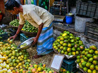 A shopkeeper is selling mangoes at a fruit shop at the Chalai market in Thiruvananthapuram, Kerala, India, on April 13, 2024. The Chalai Mar...