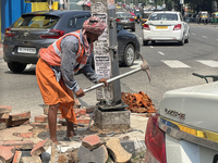 A worker is using a pick-axe while doing road construction in Thiruvananthapuram (Trivandrum), Kerala, India, on April 08, 2024. (