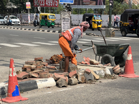 A worker is using a pick-axe while doing road construction in Thiruvananthapuram (Trivandrum), Kerala, India, on April 08, 2024. (