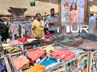 Women are shopping for designer churidars at a textile shop in Thiruvananthapuram, Kerala, India, on April 10, 2024. (