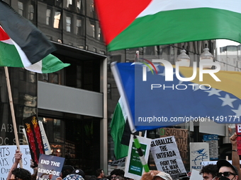 Protesters are marching in a March on the Eve of the DNC event downtown in Chicago, Illinois, United States, on August 18, 2024. Protesters...