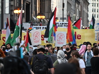 Protesters are marching in a March on the Eve of the DNC event downtown in Chicago, Illinois, United States, on August 18, 2024. Protesters...