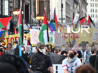 Protesters are marching in a March on the Eve of the DNC event downtown in Chicago, Illinois, United States, on August 18, 2024. Protesters...