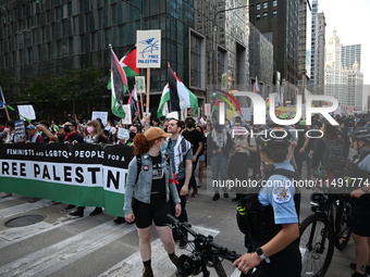 Protesters are marching in a March on the Eve of the DNC event downtown in Chicago, Illinois, United States, on August 18, 2024. Protesters...