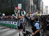 Protesters are marching in a March on the Eve of the DNC event downtown in Chicago, Illinois, United States, on August 18, 2024. Protesters...