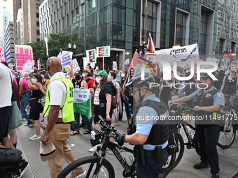 Protesters are marching in a March on the Eve of the DNC event downtown in Chicago, Illinois, United States, on August 18, 2024. Protesters...