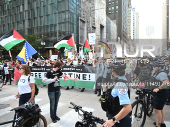 Protesters are marching in a March on the Eve of the DNC event downtown in Chicago, Illinois, United States, on August 18, 2024. Protesters...