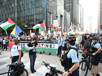 Protesters are marching in a March on the Eve of the DNC event downtown in Chicago, Illinois, United States, on August 18, 2024. Protesters...