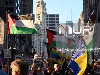 Protesters are marching in a March on the Eve of the DNC event downtown in Chicago, Illinois, United States, on August 18, 2024. Protesters...