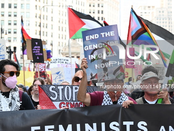 Protesters are marching in a March on the Eve of the DNC event downtown in Chicago, Illinois, United States, on August 18, 2024. Protesters...