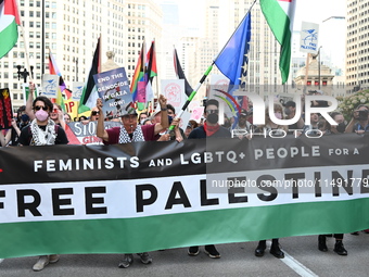 Protesters are marching in a March on the Eve of the DNC event downtown in Chicago, Illinois, United States, on August 18, 2024. Protesters...