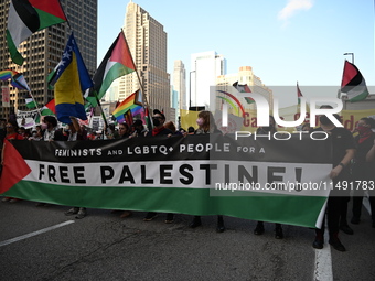 Protesters are marching in a March on the Eve of the DNC event downtown in Chicago, Illinois, United States, on August 18, 2024. Protesters...