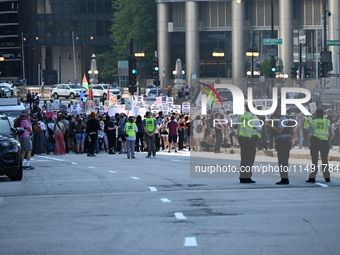 Protesters are marching in a March on the Eve of the DNC event downtown in Chicago, Illinois, United States, on August 18, 2024. Protesters...