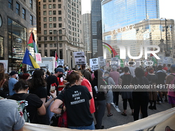 Protesters are marching in a March on the Eve of the DNC event downtown in Chicago, Illinois, United States, on August 18, 2024. Protesters...