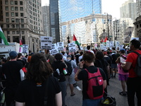 Protesters are marching in a March on the Eve of the DNC event downtown in Chicago, Illinois, United States, on August 18, 2024. Protesters...