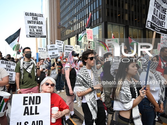 Protesters are marching in a March on the Eve of the DNC event downtown in Chicago, Illinois, United States, on August 18, 2024. Protesters...