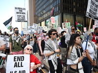 Protesters are marching in a March on the Eve of the DNC event downtown in Chicago, Illinois, United States, on August 18, 2024. Protesters...