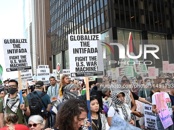 Protesters are marching in a March on the Eve of the DNC event downtown in Chicago, Illinois, United States, on August 18, 2024. Protesters...