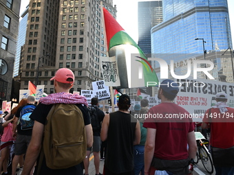 Protesters are marching in a March on the Eve of the DNC event downtown in Chicago, Illinois, United States, on August 18, 2024. Protesters...