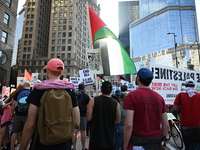 Protesters are marching in a March on the Eve of the DNC event downtown in Chicago, Illinois, United States, on August 18, 2024. Protesters...