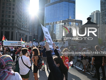 Protesters are marching in a March on the Eve of the DNC event downtown in Chicago, Illinois, United States, on August 18, 2024. Protesters...