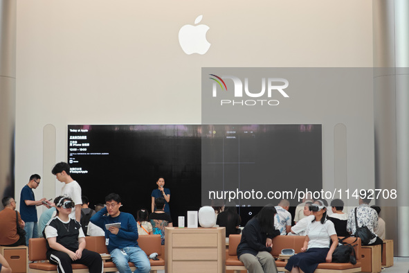 Customers are trying Apple Vision Pro at the largest Apple store in Asia in Shanghai, China, on August 19, 2024. 