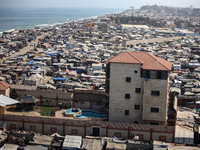 Displaced Palestinians, who are fleeing their house due to Israeli strikes, are sheltering at a tent camp amid the ongoing conflict between...