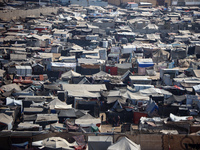 Displaced Palestinians, who are fleeing their house due to Israeli strikes, are sheltering at a tent camp amid the ongoing conflict between...