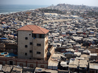 Displaced Palestinians, who are fleeing their house due to Israeli strikes, are sheltering at a tent camp amid the ongoing conflict between...