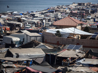 Displaced Palestinians, who are fleeing their house due to Israeli strikes, are sheltering at a tent camp amid the ongoing conflict between...