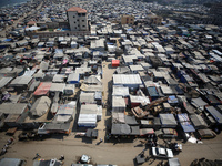 Displaced Palestinians, who are fleeing their house due to Israeli strikes, are sheltering at a tent camp amid the ongoing conflict between...