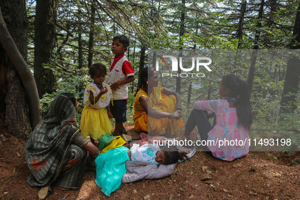 Hindu devotees are taking rest before paying obeisance on the occasion of the Raksha Bandhan festival at the Shankaracharya temple in Srinag...