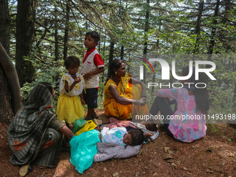 Hindu devotees are taking rest before paying obeisance on the occasion of the Raksha Bandhan festival at the Shankaracharya temple in Srinag...