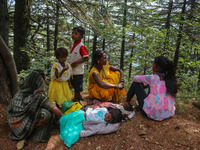 Hindu devotees are taking rest before paying obeisance on the occasion of the Raksha Bandhan festival at the Shankaracharya temple in Srinag...