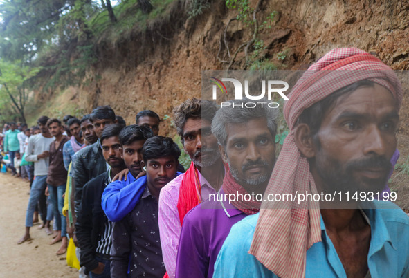 Hindu devotees are waiting in a long queue to pay their obeisance on the occasion of the Raksha Bandhan festival at the Shankaracharya templ...