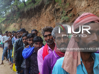 Hindu devotees are waiting in a long queue to pay their obeisance on the occasion of the Raksha Bandhan festival at the Shankaracharya templ...